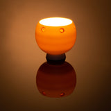 Elegant Night Light Bowl with a golden brown hand carved circle design, lit